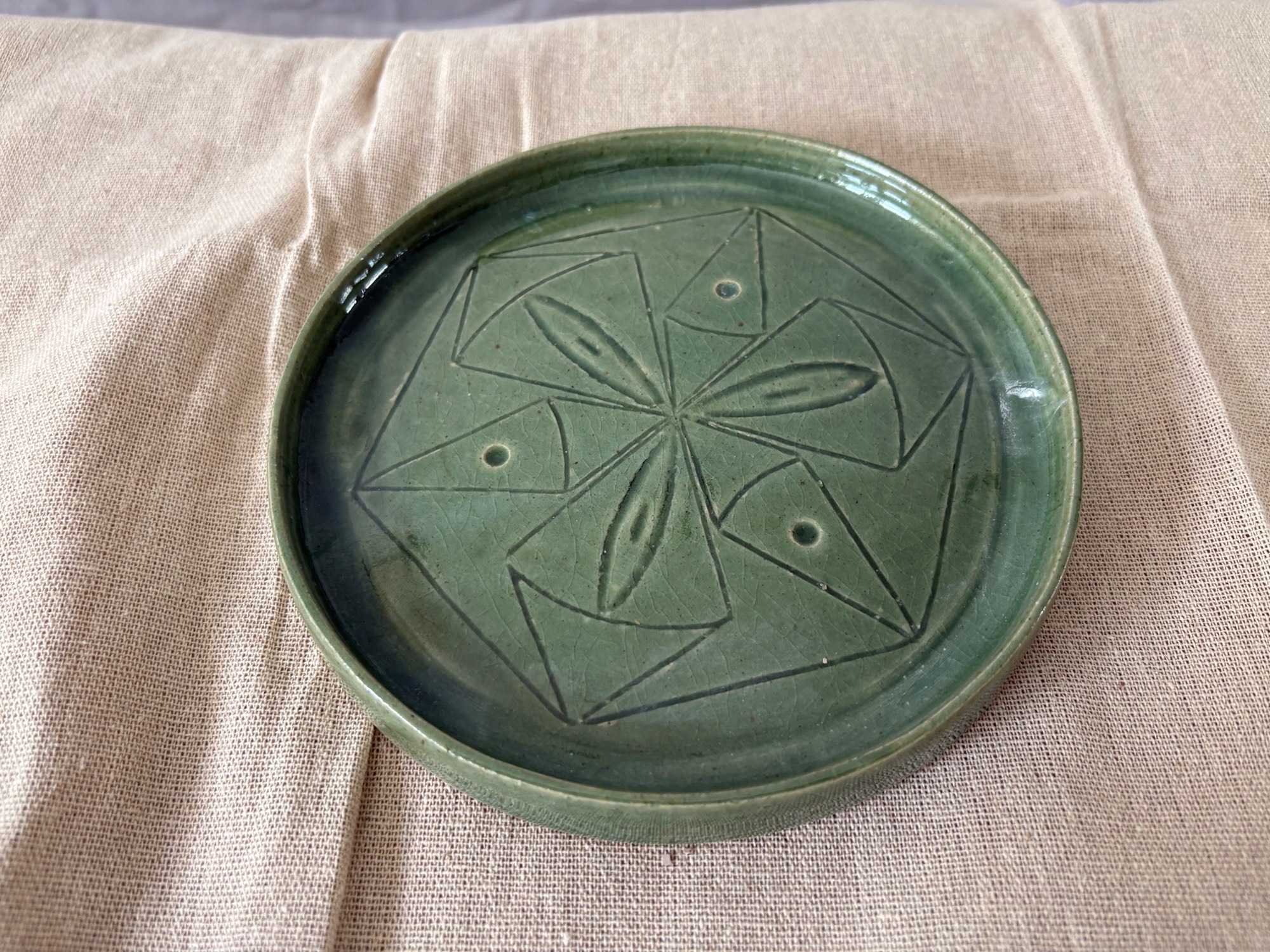 Green mandala-style side plate with carved decoration