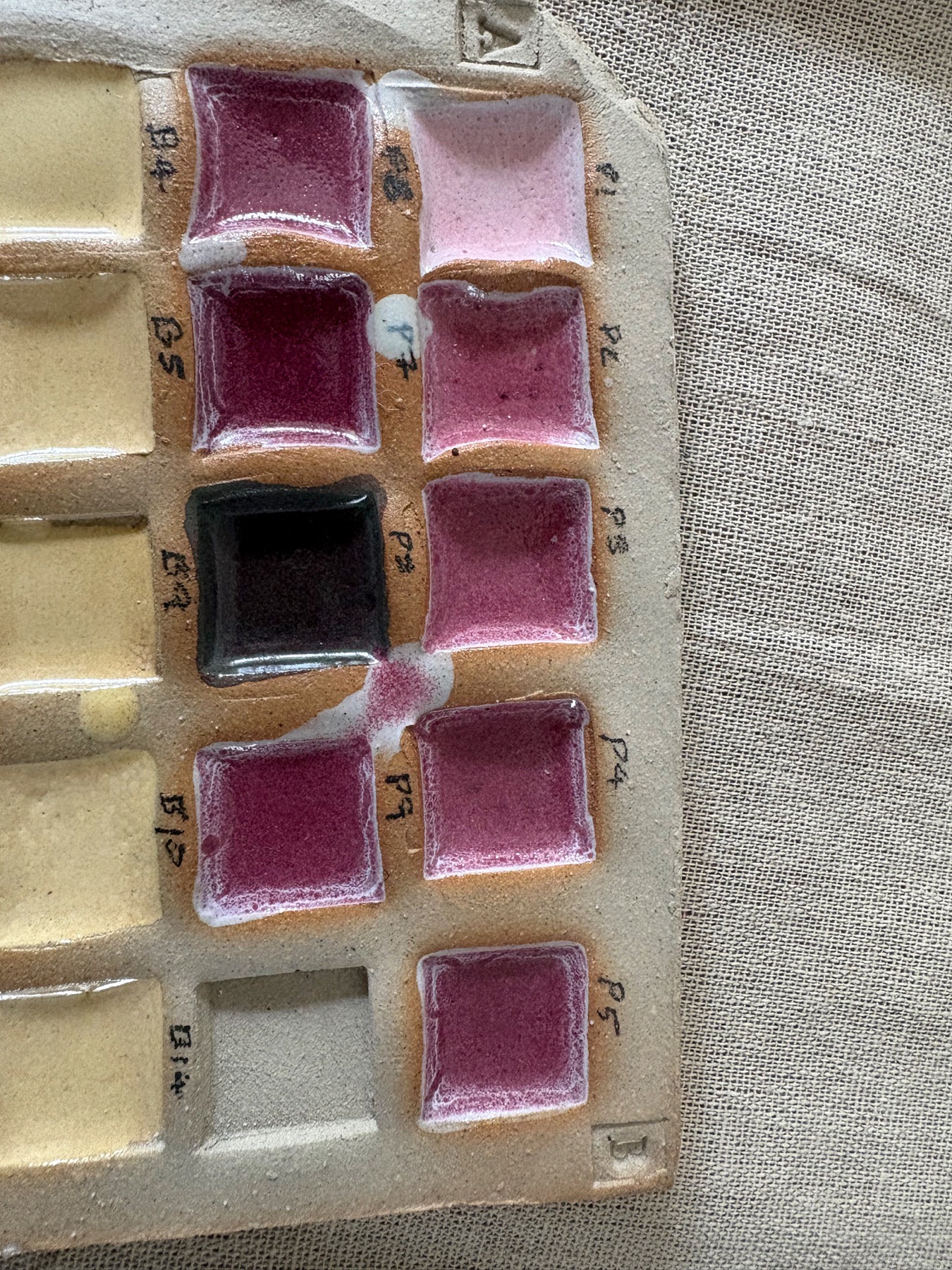 Flat grid of pink glaze test samples