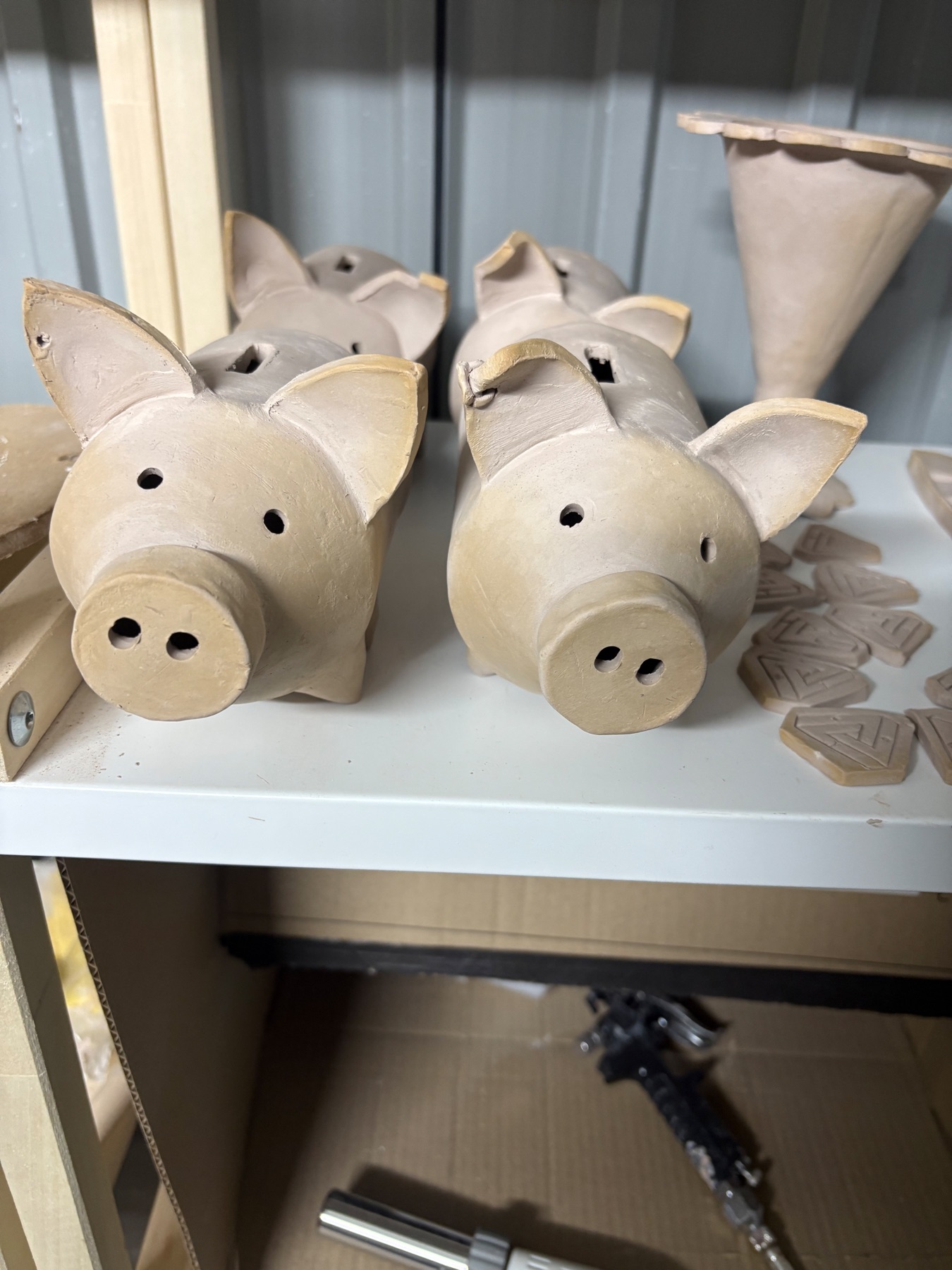 Close view of bisque-fired ceramic piggy-bank tests